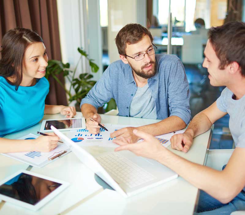 team brainstorming around a computer
